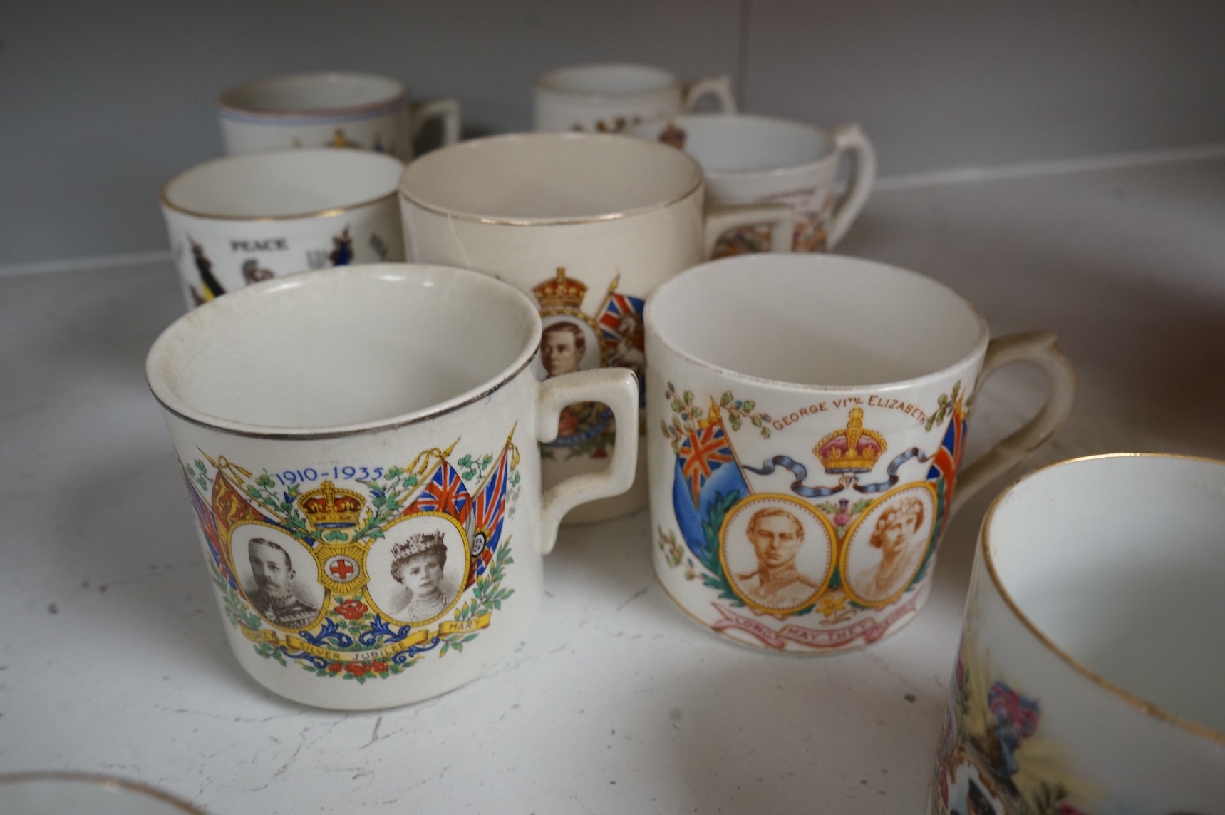 A lithophane commemorative mug and ten others to include George VI and Elizabeth coronation 1937, largest 9.5cm high